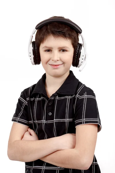 Portrait of a happy smiling young boy listening to music on headphones Stock Picture