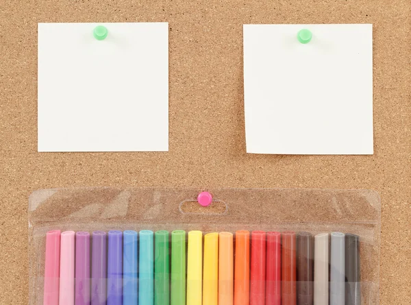 Color markers with notes on cork board — Stock Photo, Image