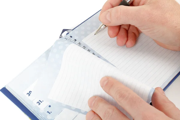 Close-up of hand beginning to write on notes — Stock Photo, Image