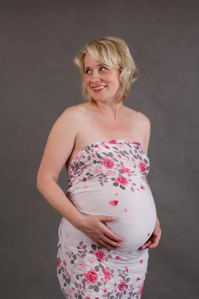 Beautiful pregnant woman tenderly holding her tummy — Stock Photo, Image