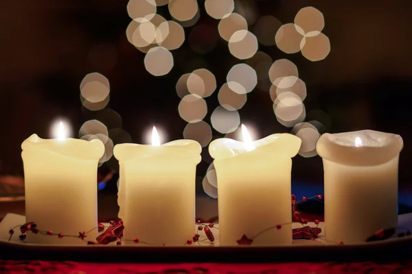 Burning candle with christmas tree bokeh — Stock Photo, Image