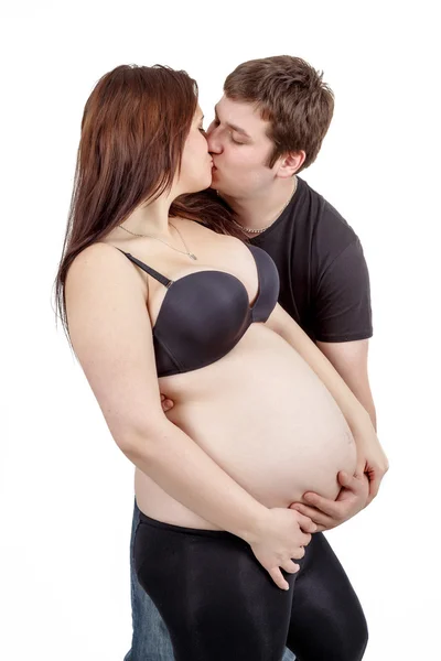 Любящая счастливая пара, муж целует беременную женщину — стоковое фото