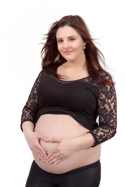 Beautiful pregnant woman tenderly holding her tummy isolated on white background — Stock Photo, Image