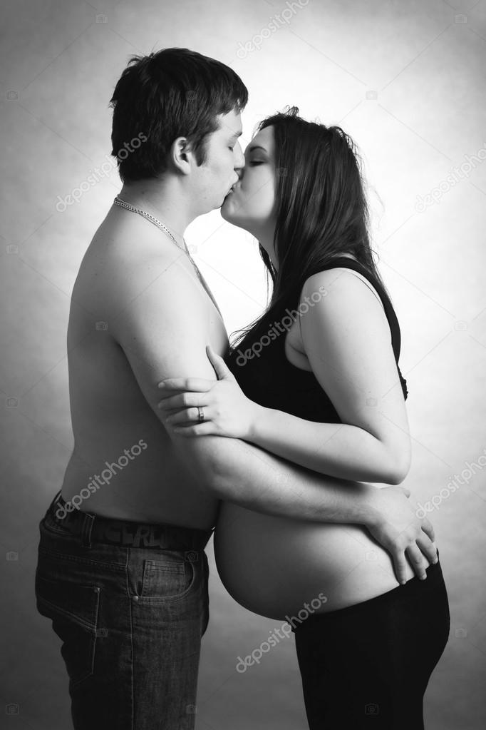 loving happy couple, husband kissing pregnant woman