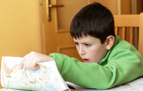 Bored and tired boy doing homework — Stock Photo, Image