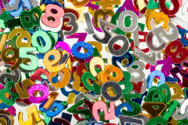 Pequenos números de cores fundo confete — Fotografia de Stock