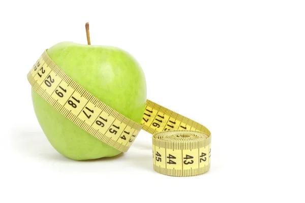 Green apple with a measuring tape and heart symbol isolated — Stock Photo, Image