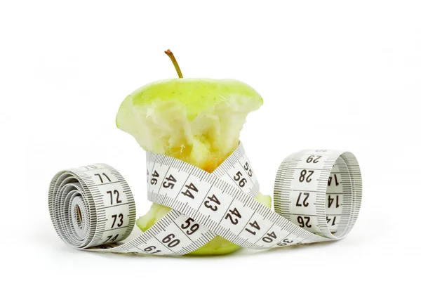 Green bitten apple isolated on white with measuring tape — Stock Photo, Image