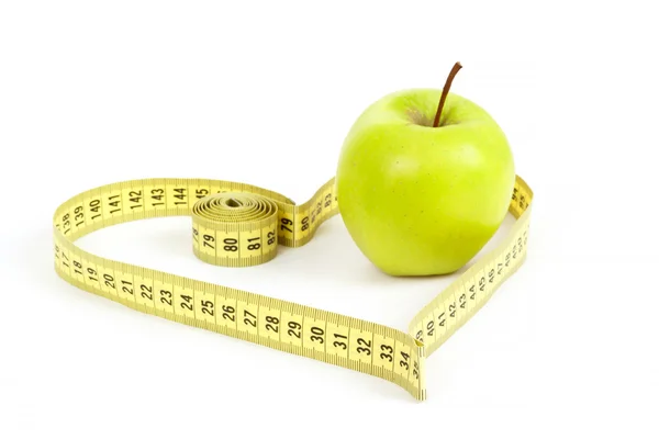 Green apple with a measuring tape and heart symbol isolated — Stock Photo, Image