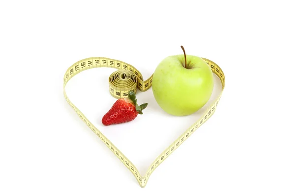 Green apple with a measuring tape and heart symbol isolated — Stock Photo, Image