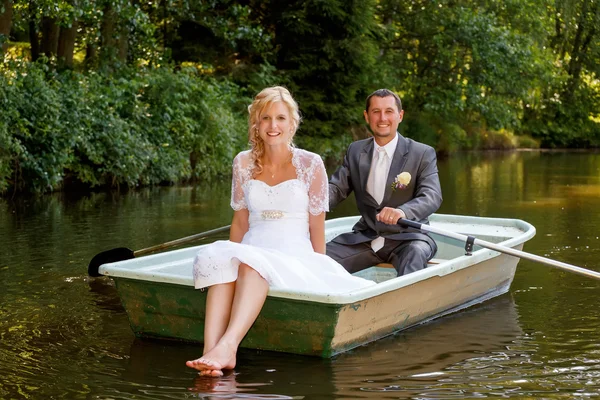 Young just married bride and groom on boat — Stock Photo, Image