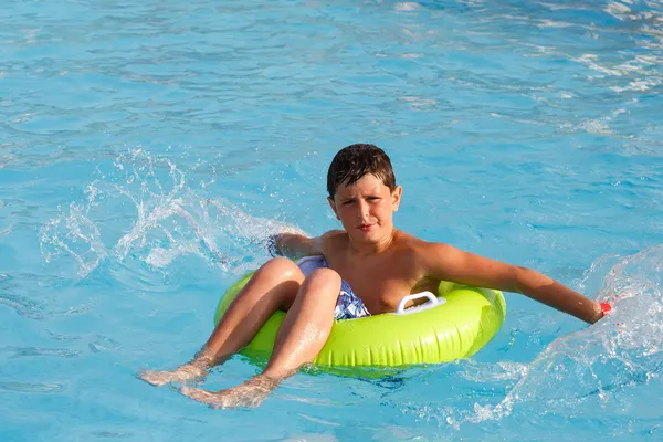 Boys swimsuit floating in the pool float — Stock Photo, Image