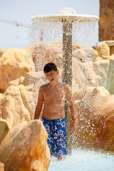 Boy in tunisian aquapark resort under shower — Stock Photo, Image