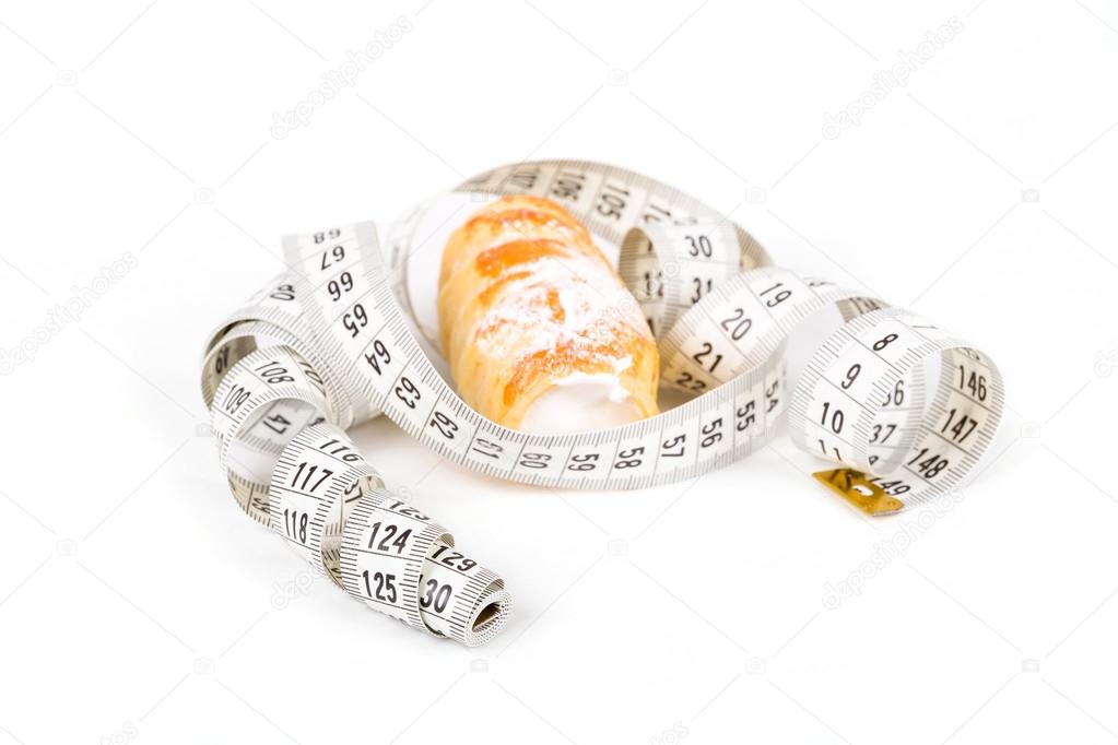 concept of slimming, cakes with measuring tape