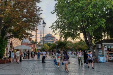 Istanbul, Turkey - August 5, 2022: View of people resting in Sultan Ahmed Blue Mosque park Istanbul, Turkey