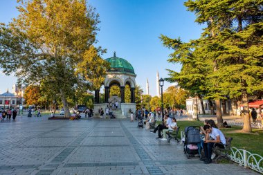 Istanbul, Turkey - August 5, 2022: View of people resting in Sultan Ahmed Blue Mosque park Istanbul, Turkey