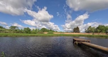 Timelapse, moving clouds over small frozen pond. Czech highland vysocina european countryside