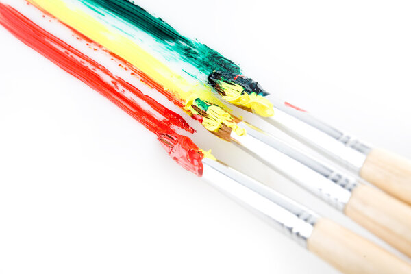 used paint brushes of different colors