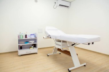 Boş beyaz şekerleme masası, sandalye, spa salonunda bir sonraki müşteri için hazır.