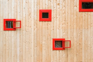 Open red windows on a wooden wall clipart