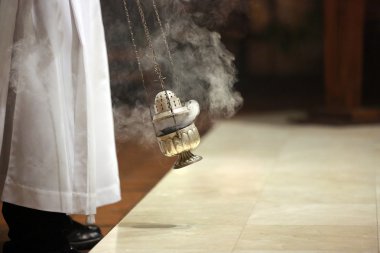 Incense during Mass at the altar clipart