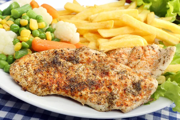 Chicken grilled fillet in herbs with fresh vegetable and fries — Stock Photo, Image