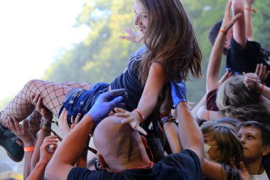 JAROCIN, POLAND - JULY 20: Young girl at a rock concert clipart