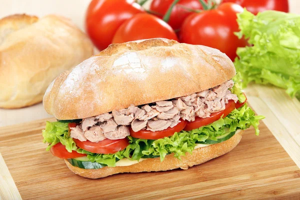 Sandwich with tuna and tomato on wood background — Stock Photo, Image