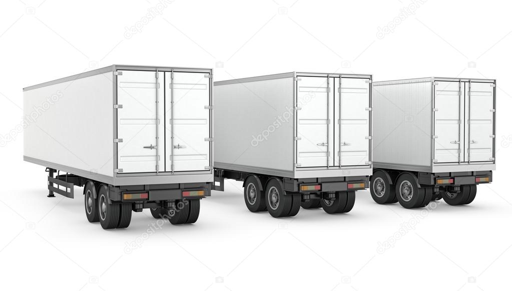 Three blank white parked semi trailers