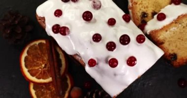 Christmas cake with cranberries. Christmas homebaked. Christmas stollen and Christmas decorations. Super slow motion.