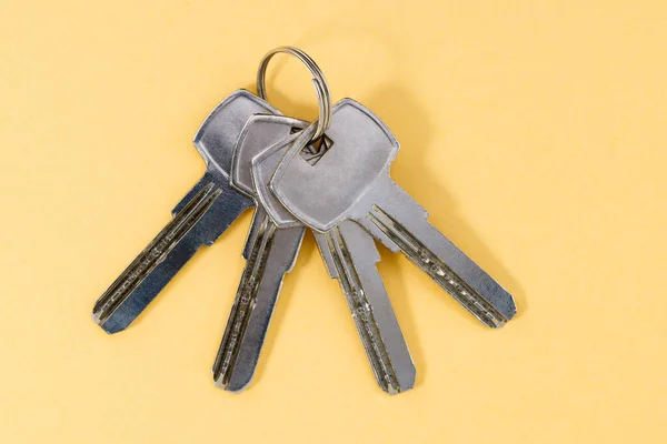 Bunch Keys Yellow Background Copy Space — Stok Foto