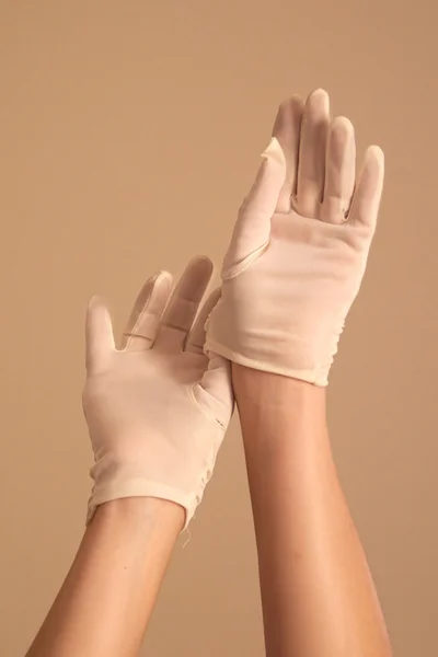 Woman adjusting vintage white gloves — Stock Photo, Image