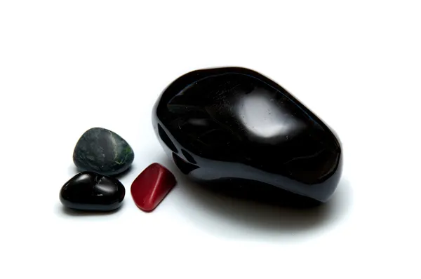 Collection of smooth dark stones over white — Stock Photo, Image