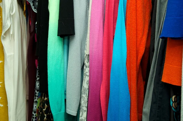 Close up of clothing hanging in closet — Stock Photo, Image