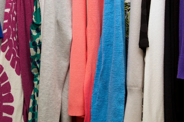 Close up of clothes hanging in closet — Stock Photo, Image