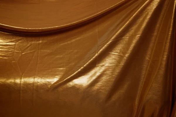 Altın kumaş arka plan bol dökümlü — Stok fotoğraf