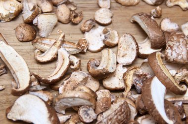 Top view of cut and dried medicinal birch polypore mushrooms on wooden cutting board, used in alternative medicine.