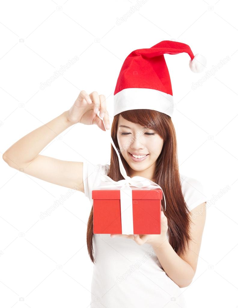 Young woman trying to open christmas gift box