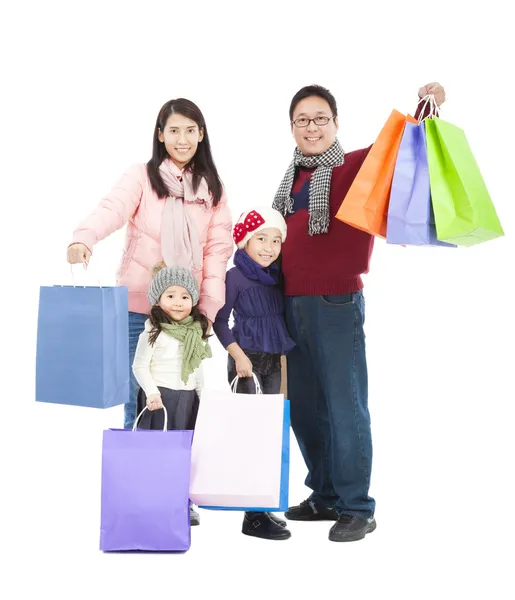 Happy asian family with shopping bag in winter clothing — Stock Photo, Image