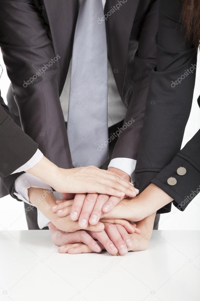 Business team with hand together on the table for teamwork conce