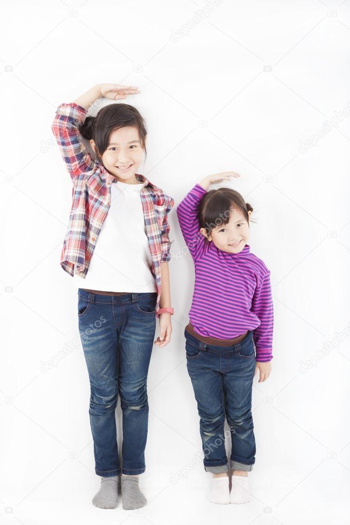 Two beautiful asian little girls standing together