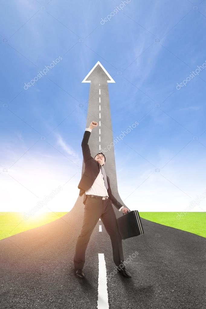 Success businessman with the road rising up background