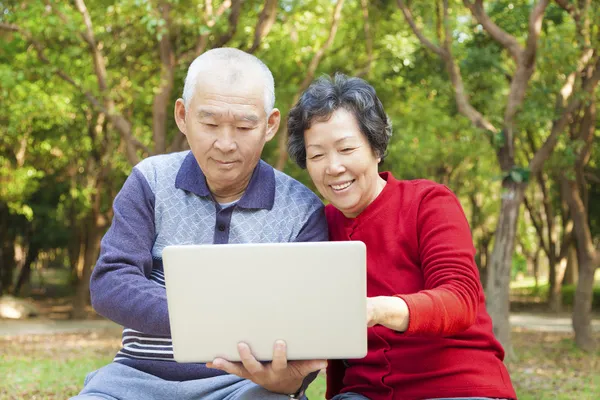 Щаслива азіатська старша пара з ноутбуком — стокове фото