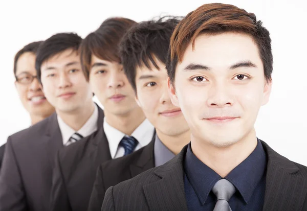 Happy business man smiling with colleagues in background — ストック写真