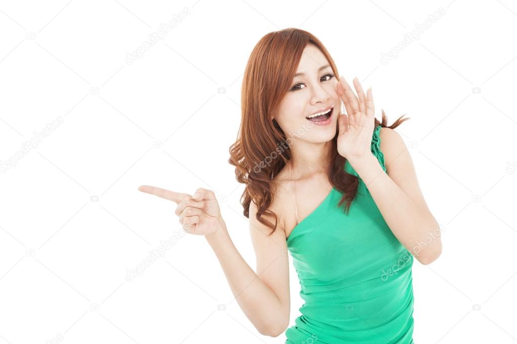 smiling asian young woman shouting and pointing
