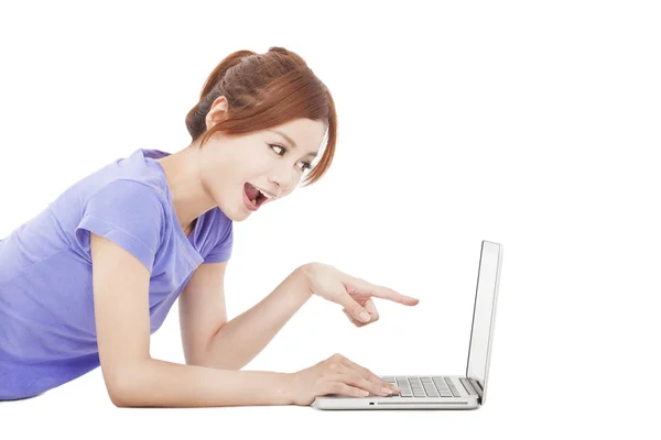 Happy girl pointing to the laptop — Stock Photo, Image