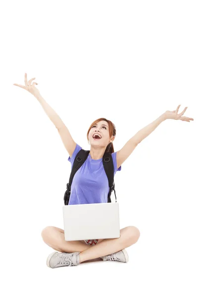 Feliz jovem mulher sentada com laptop e olhando para cima — Fotografia de Stock