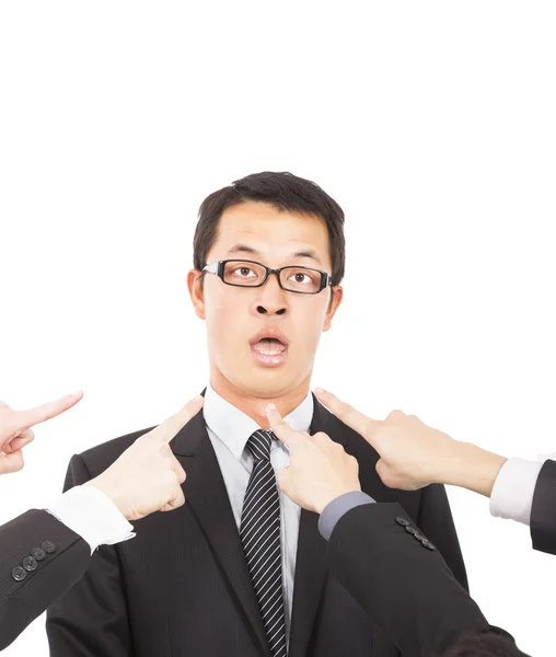 All hands pointing towards surprised businessman — Stock Photo, Image