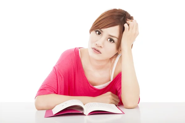 Embarrassed school girl studying with book — Stock Photo, Image