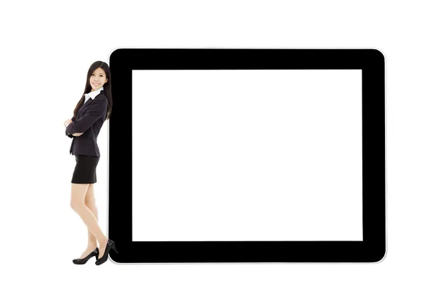 Young businesswoman standing with tablet and blank screen — Stock Photo, Image